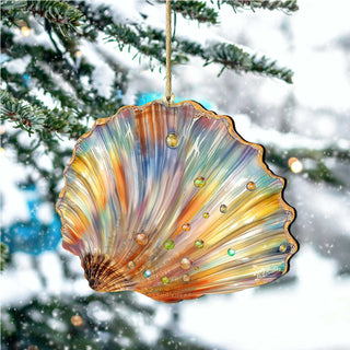 A colorful, multicolored seashell ornament hangs from a tree branch, with snowflakes visible in the background.