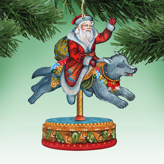 A colorful ornament depicting Santa Claus riding a gray wolf on a carousel, with a red and gold base and a green and gold design.