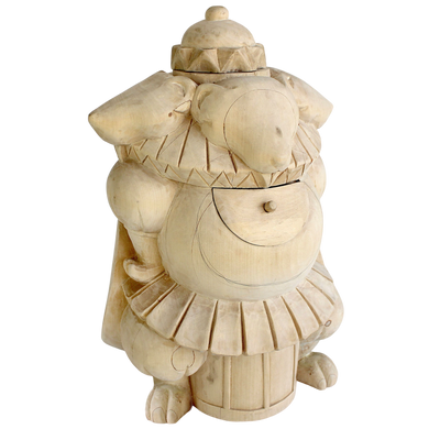 A wooden sculpture of a whimsical, anthropomorphic animal with a hat and a large, round object on its back.