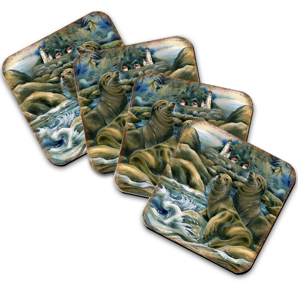 A set of four square coasters featuring a painting of seals on rocky shores with a lighthouse in the background.