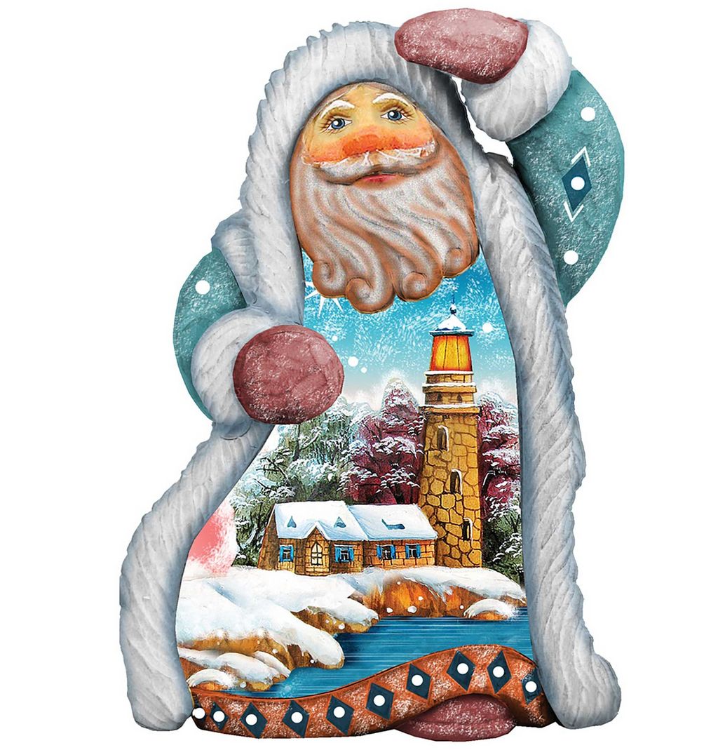 A colorful, hand-painted Santa Claus figurine with a winter landscape scene inside, featuring a lighthouse, snow-covered houses, and a snowy river.