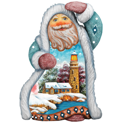 A colorful, hand-painted Santa Claus figurine with a winter landscape scene inside, featuring a lighthouse, snow-covered houses, and a snowy river.