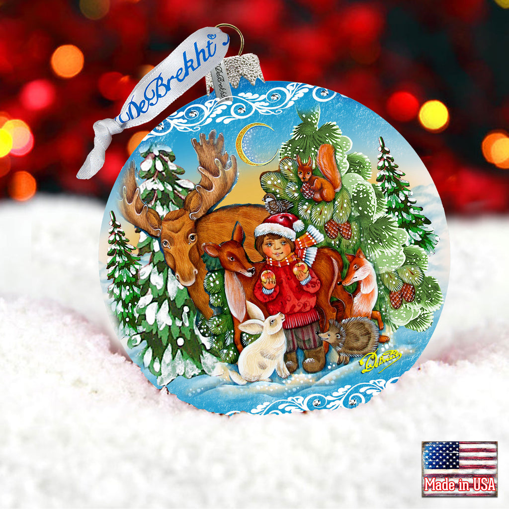 a glass ornament with a christmas scene on it