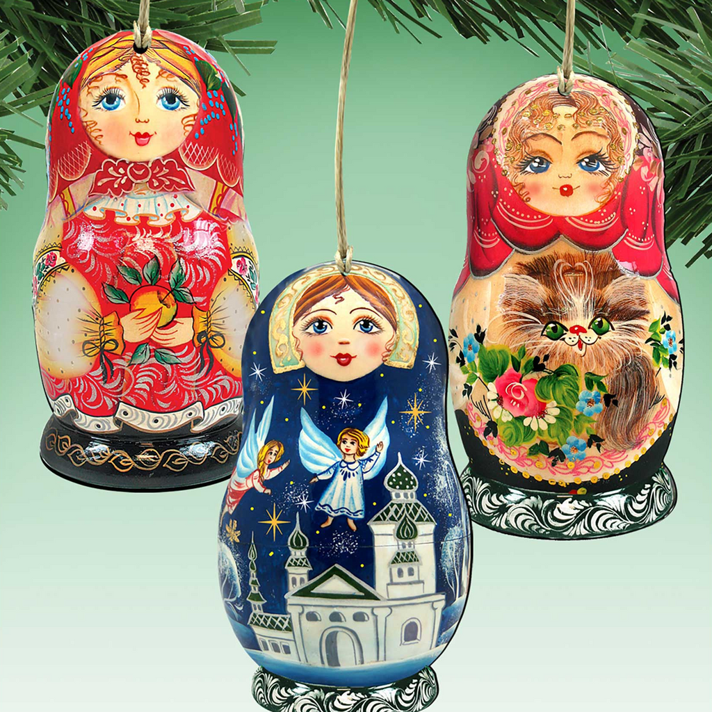 three colorful Russian nesting dolls or Matryoshka dolls hanging from a string, each with unique designs and patterns.
