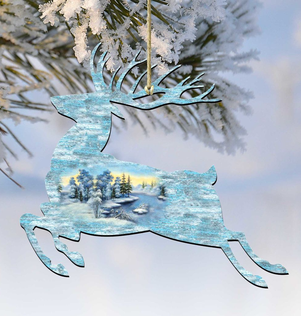 A decorative ornament in the shape of a deer, with a snowy winter landscape visible through its body.