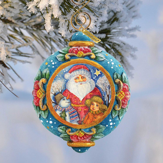 A colorful ornament featuring a Santa Claus figure, a snowman, and a girl, hanging from a tree branch against a snowy background.