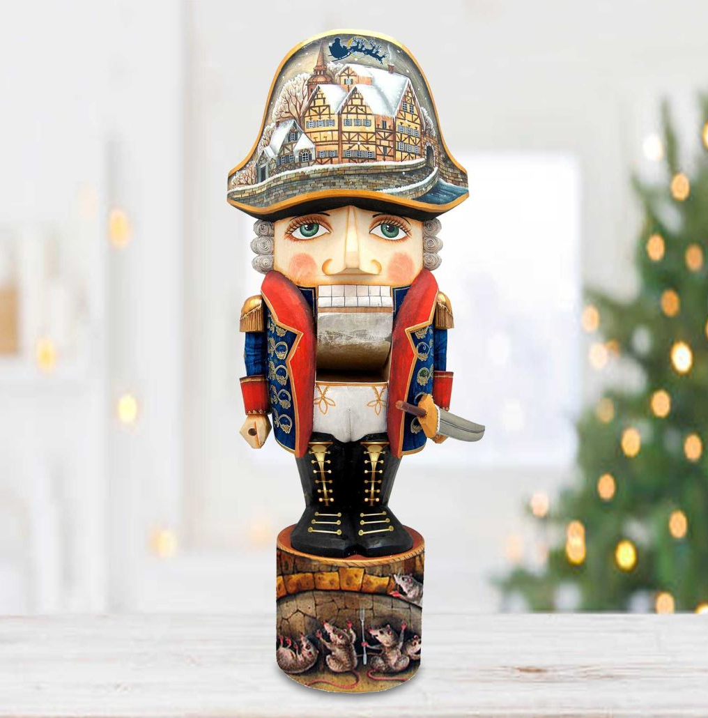 A nutcracker figurine with a detailed design, including a hat and a castle-like background, is displayed on a wooden surface.