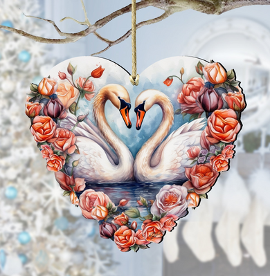 A heart-shaped ornament featuring two swans with their necks intertwined, surrounded by a floral arrangement of roses and other flowers.