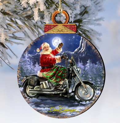 A round ornament featuring a Santa Claus figure riding a motorcycle through a snowy landscape at night.