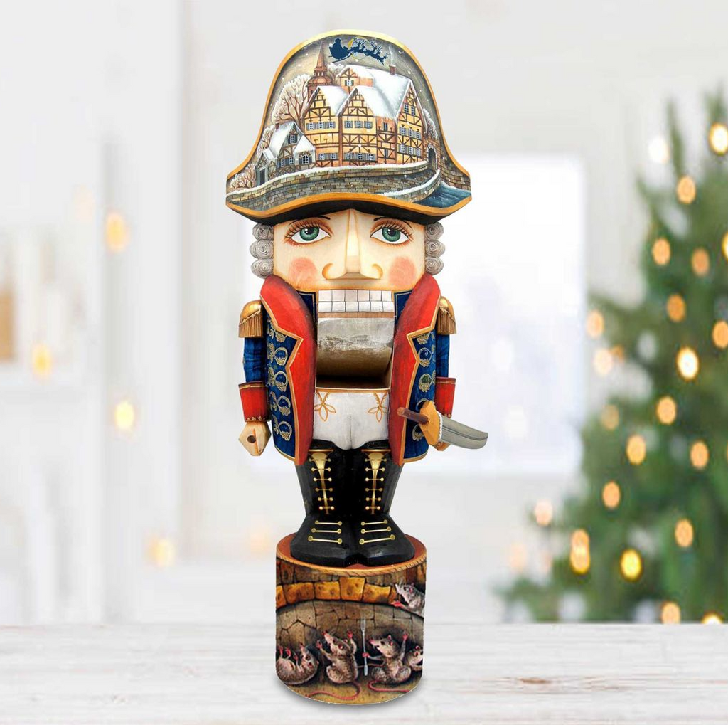 A wooden nutcracker figure with a detailed design, including a hat with a castle or palace scene, stands on a wooden base.